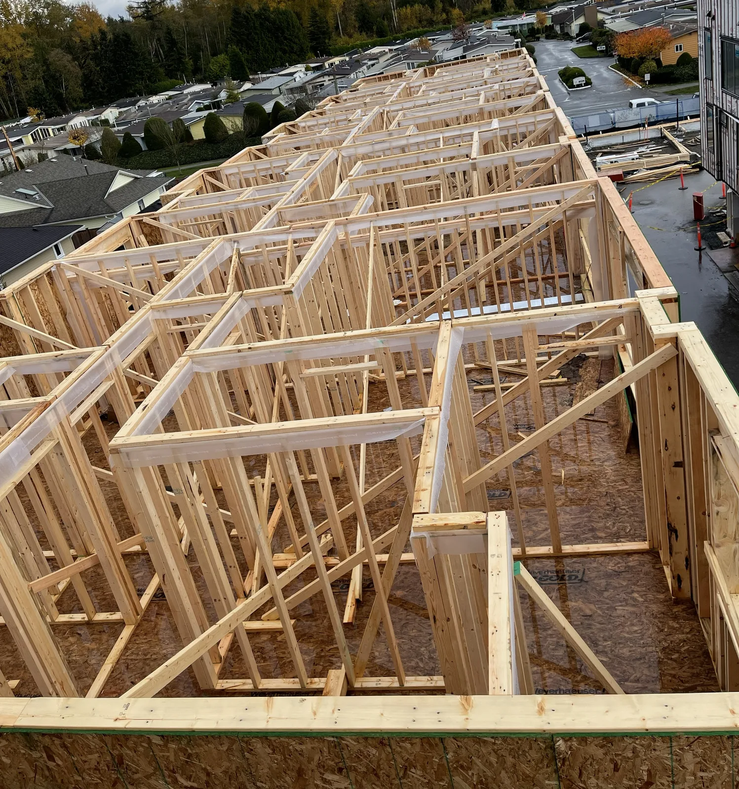 Long row of framed townhouse units viewed from above