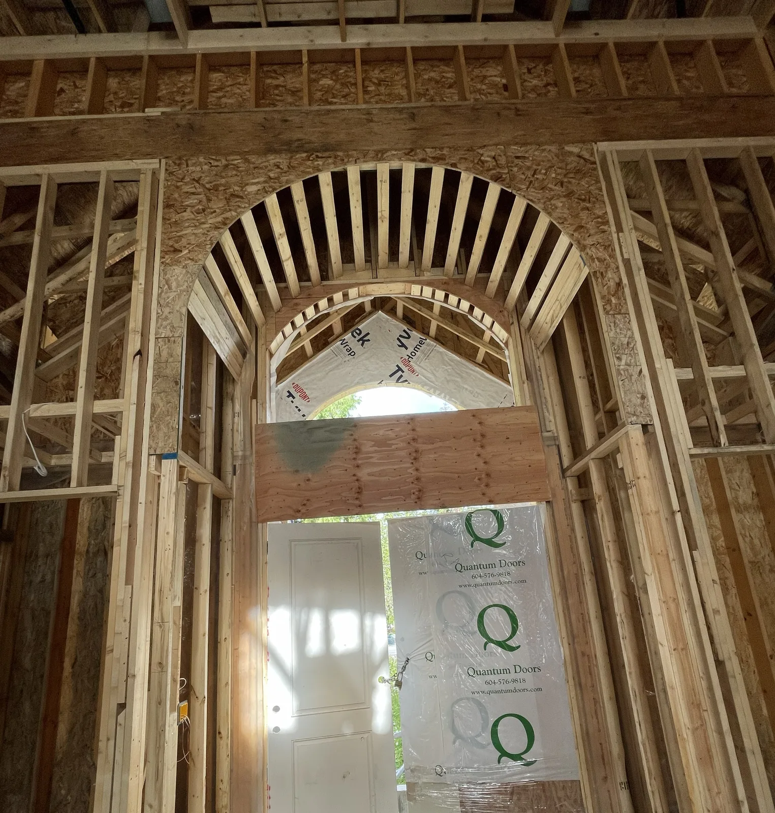 Custom curved wood framing around an arched interior opening