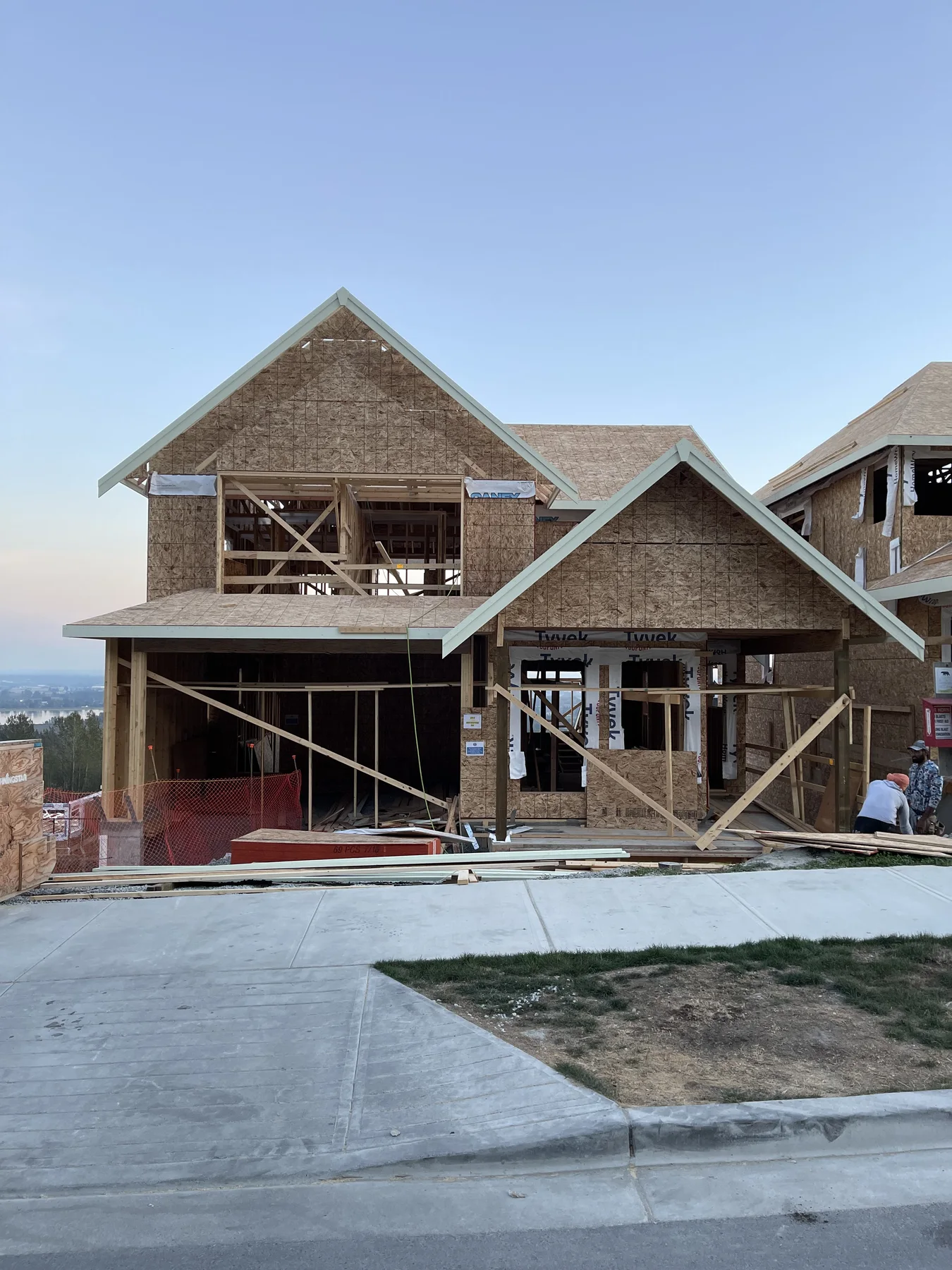 Custom home with multiple gable rooflines under structural framing construction