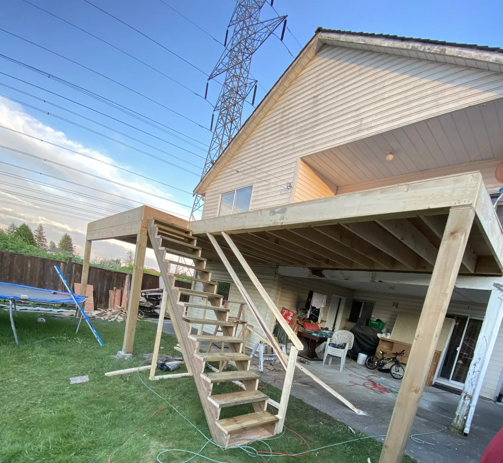 Elevated wood deck frame with stairs and support posts