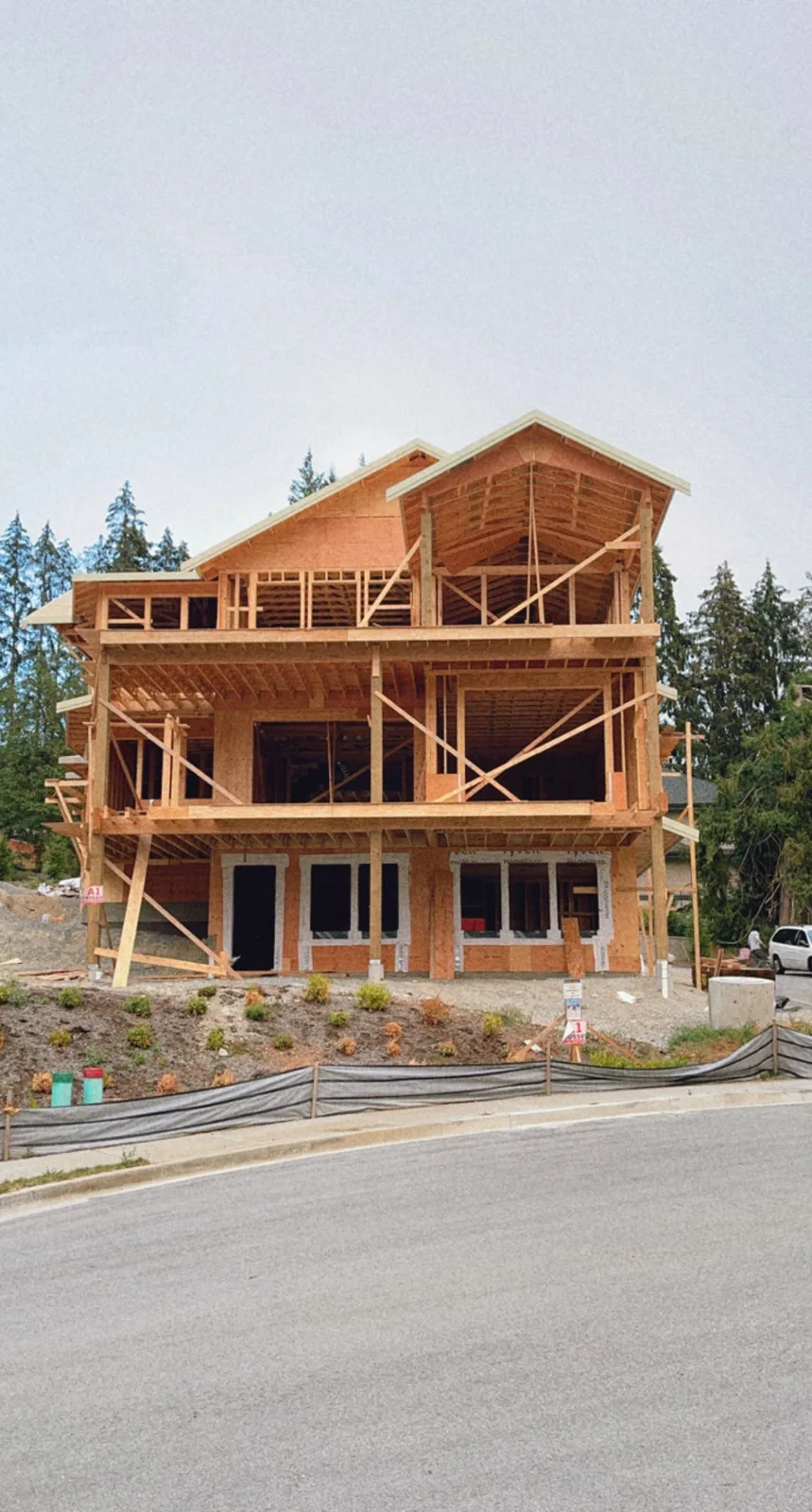 Multi-level house showing structural roof and wall framing